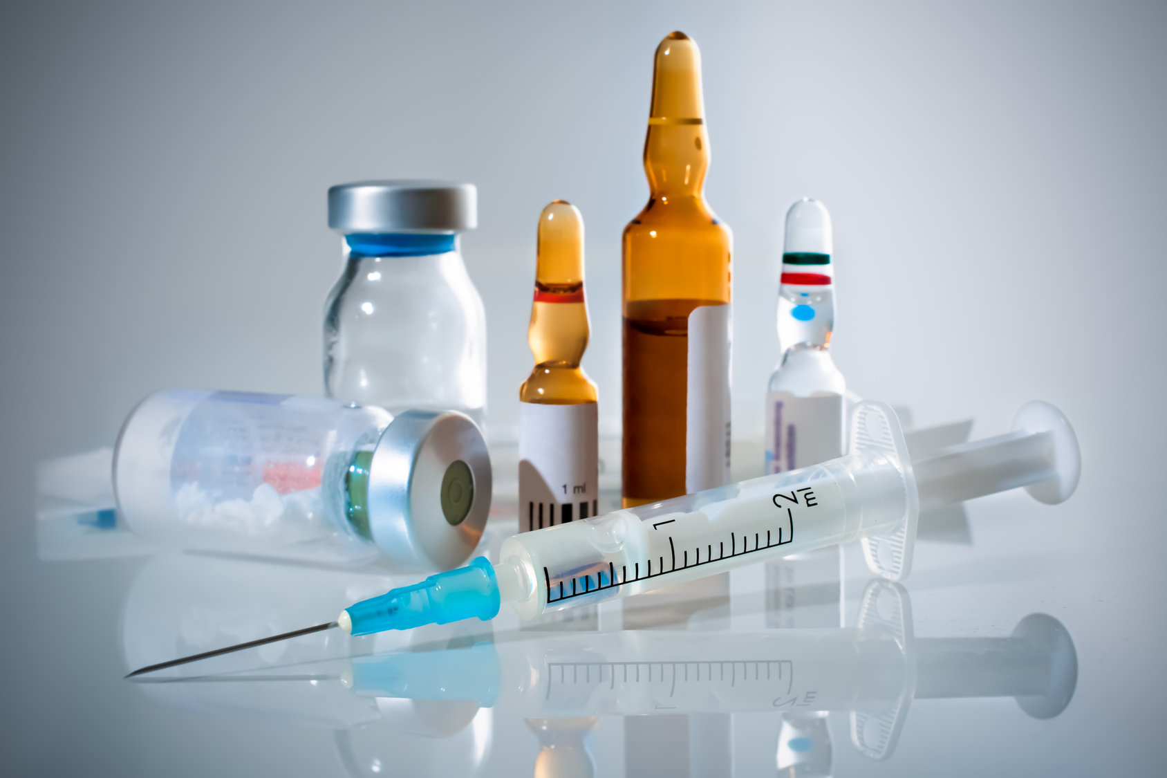 Vials, ampoules and a syringe of injectable drugs